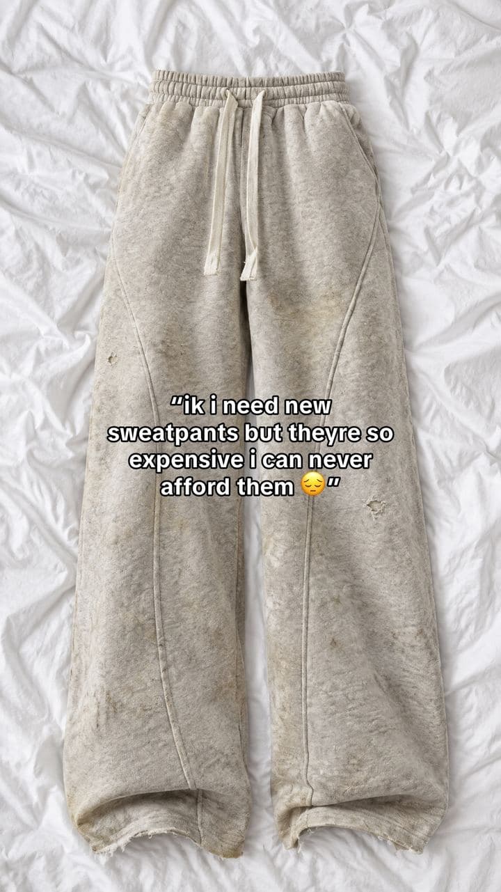 Stained old sweatpants on white sheets with the text: ik i need new sweatpants but theyre so expensive